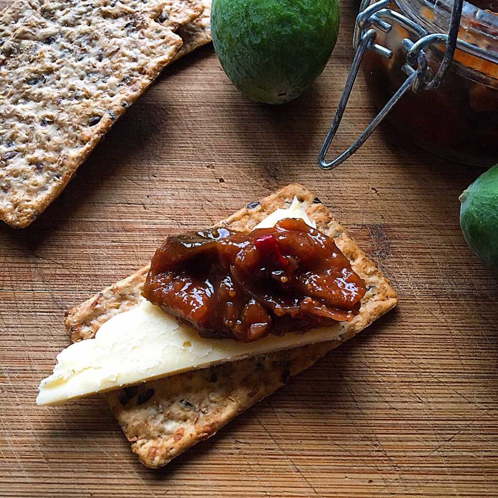 Homemade feijoa skin syrup in a glass bottle with lemon verbena